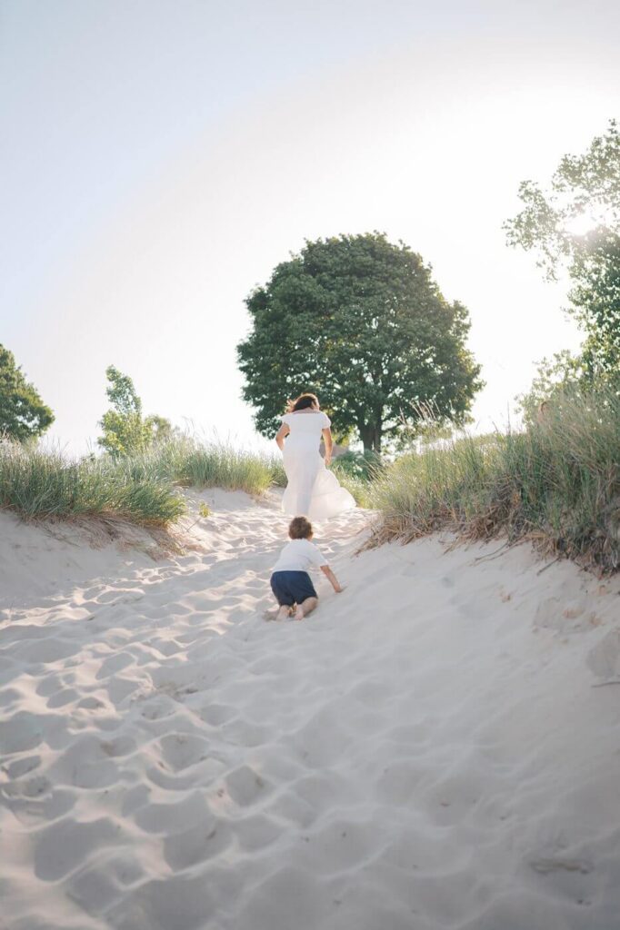 Family walking through shaded dunes at South Beach, South Haven